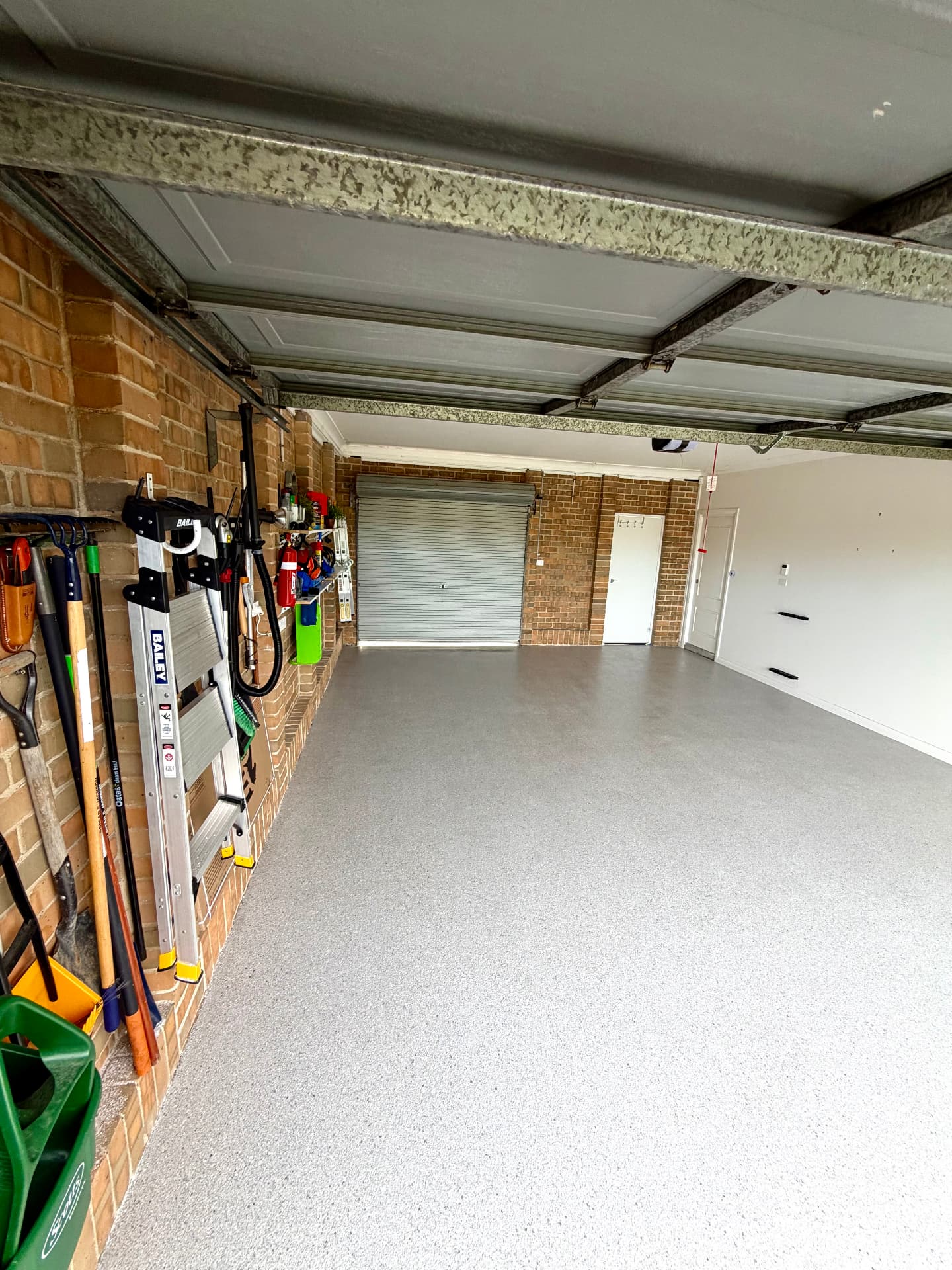 Double garage finished with a light grey flake epoxy floor
