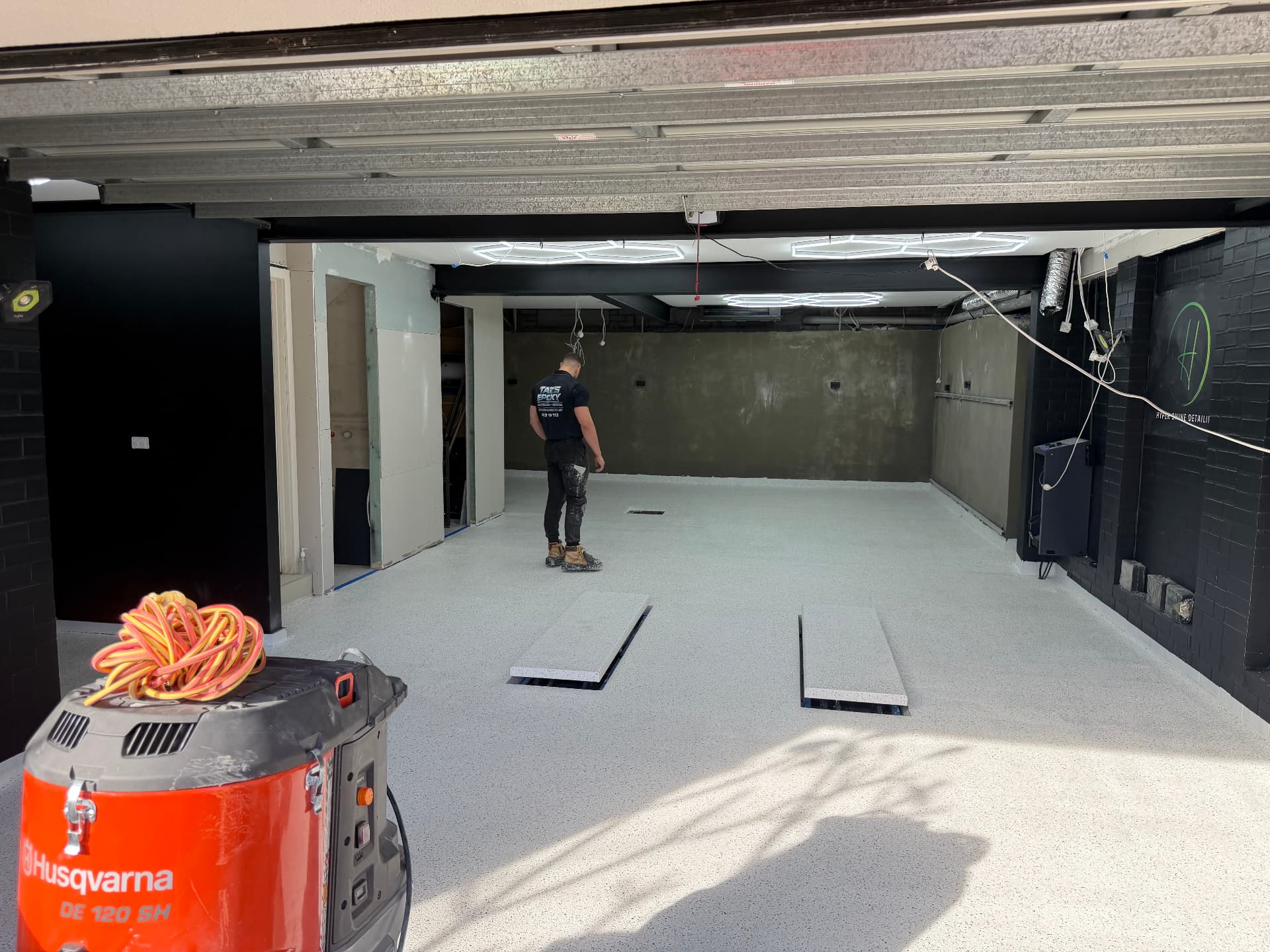 Wide view of a light flake epoxy garage floor installed by Taz's Epoxy Co